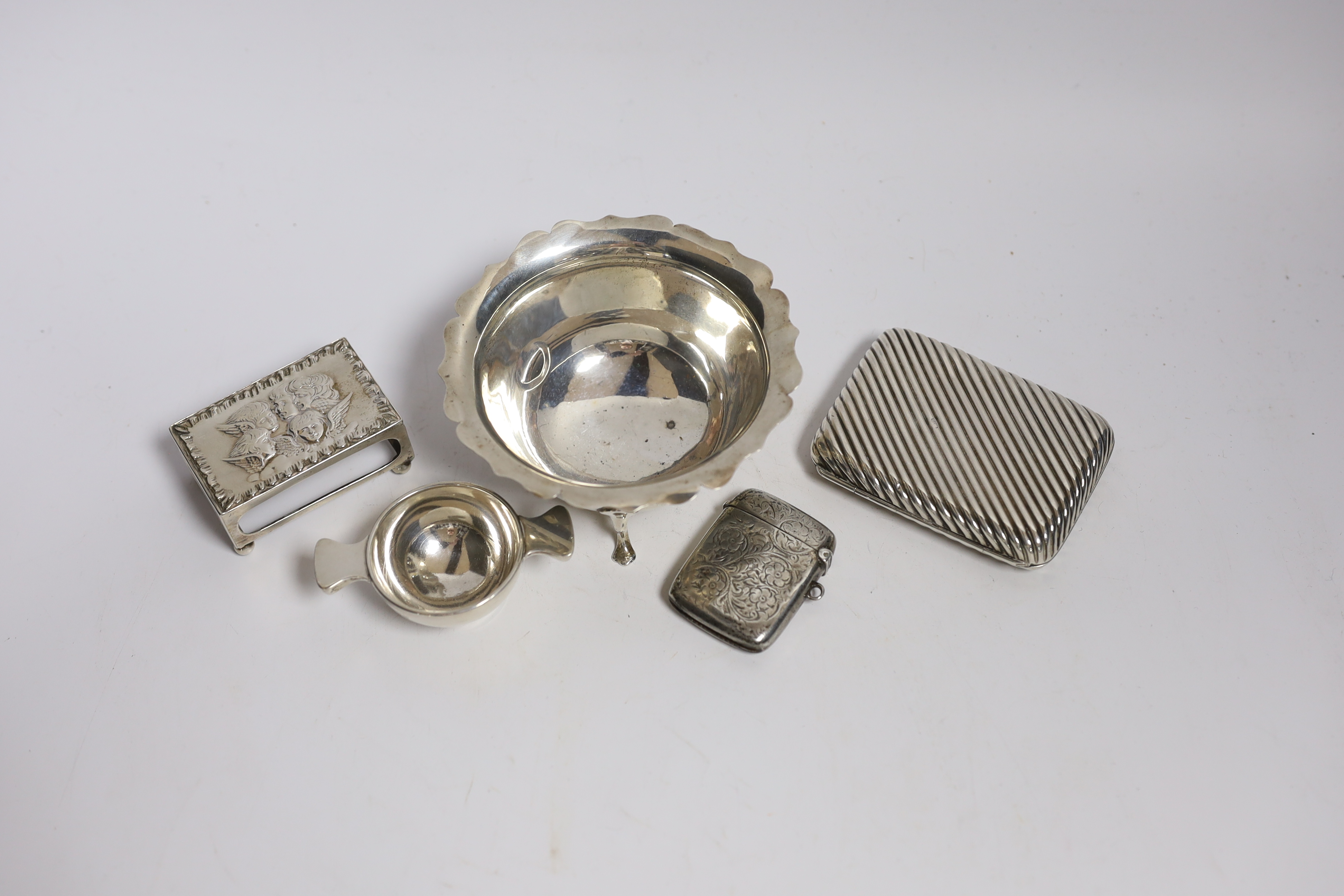 A silver cigarette case, small silver quaich, silver bowl and silver matchbox sleeve.